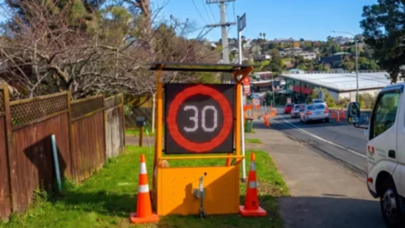 Portable temporary speed sign displaying thirty kilometres per hour in an urban worksite
